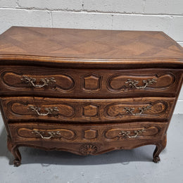 Lovely French nicely carved chest of 3 drawers with a parquetry top, with decorative handles and lovely carving. In good detailed condition.