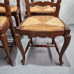 Lovely set of six French oak rush seated provincial dining chairs. They have been sourced from France and are in good detailed condition.
