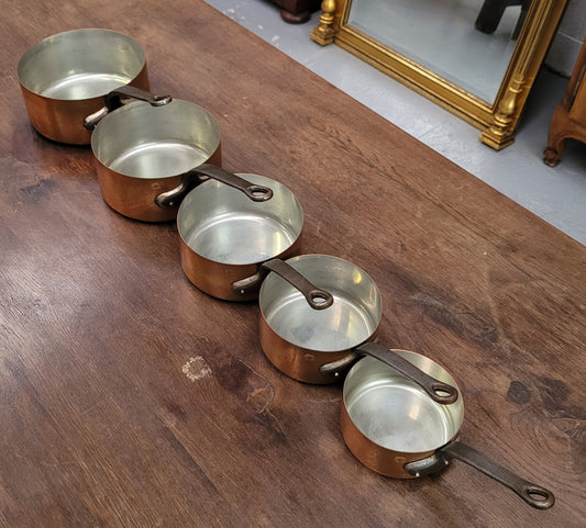 Set of five copper sauce pans with foundry stamp. They have been sourced from France and are in good original detailed condition.