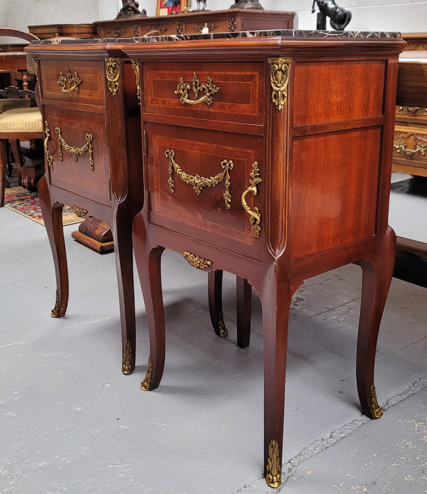 Appealing Louis XV style high quality bedside cabinets with black Portoro marble top and bronze mounts. They have been sourced from France and are in good original condition.