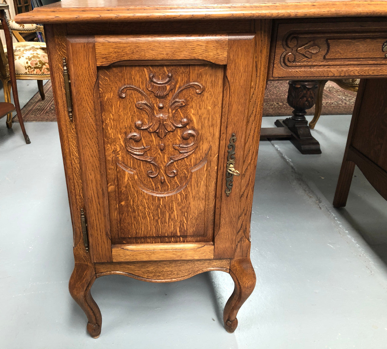 Beautifully carved French oak small desk with three drawers and a cupboard for all your storage needs. In good original condition. Great size for small spaces.