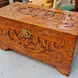 Vintage nicely carved Camphor wood chest. It has amazing carvings of boats, dragons and temples. It is in good original detailed condition.