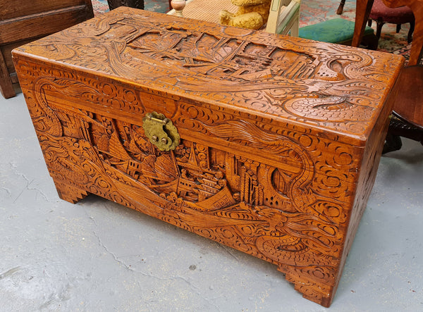 Vintage nicely carved Camphor wood chest. It has amazing carvings of boats, dragons and temples. It is in good original detailed condition.