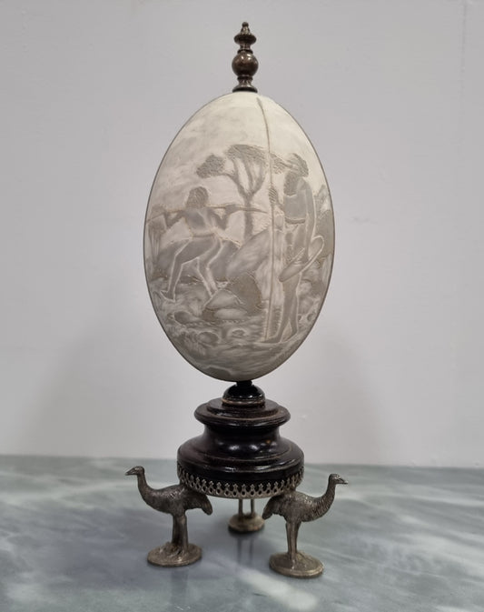 Superbly carved Emu egg on a emu metal and ebony base. It depicts an Aboriginal hunting scene and dreaming's. It is in good original condition, please view photos as they help form part of the description.