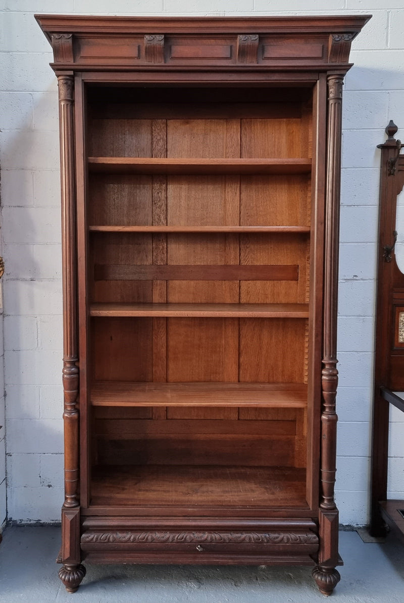 Henry II style 19th century walnut open bookcase with drawer which was originally an armoire now converted to a bookcase. It comes with four adjustable shelves. Is in good detailed condition.