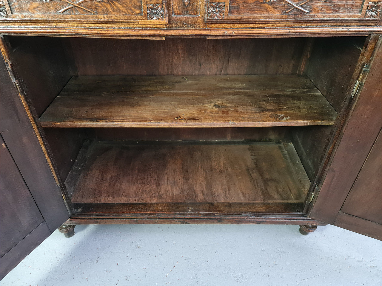 18th century French Oak Tall sideboard with beautiful carvings. It has plenty of storage with two drawers at the top and two doors at the bottom with a fixed shelf inside. It is in good restored condition.