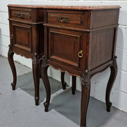Stunning pair of French dark Oak bedside cabinets with a beautiful coloured marble top. They have one drawer and cupboard. They are in good original detailed condition.