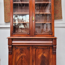 Mid 19th Century Australian Cedar and Flame Cedar tall bookcase. The top has two glass doors that open up to three adjustable shelves followed by a drawer in the middle and finishes with two beautiful wooden doors that open up to a fixed shelf. In good original detailed condition and has been sourced locally.