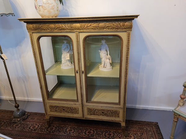 19th Century painted and gilt two door vitrine. Has one adjustable shelf and two drawers. In good original detailed condition.