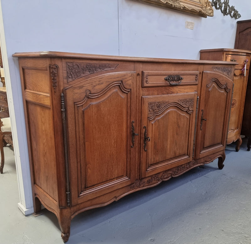 Lovely French Oak three-door sideboard with beautifully carved details and there is also a drawer. In good original detailed condition.