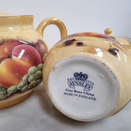 “Aynsley Orchard Gold” tea set on tray. Consisting of small teapot, lidded sugar and creamer. Please view photos as they help form part of the description.