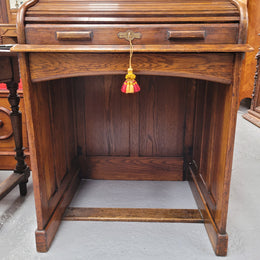 Charming petite English Oak fitted roll top desk. It has a very lovely fitted interior and a drawer at the front ideal for a unit or apartment. Sourced locally and in good original detailed condition.