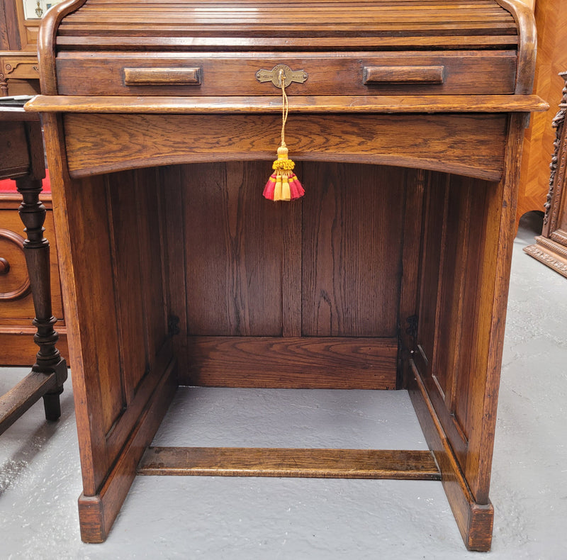 Charming petite English Oak fitted roll top desk. It has a very lovely fitted interior and a drawer at the front ideal for a unit or apartment. Sourced locally and in good original detailed condition.