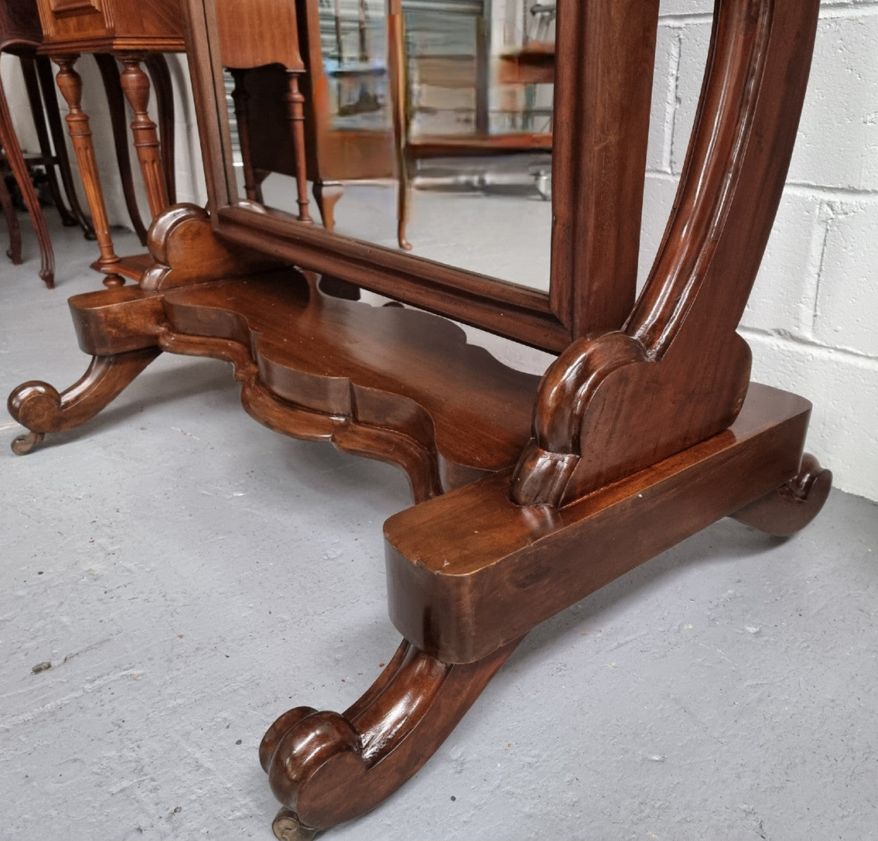 Antique Victorian 19th Century full length Mahogany cheval mirror. Mirror supported on two elegant scrolled upright support and stands on moulded base with four scrolled feet and castors.