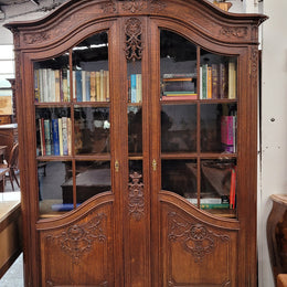 Substantial French Oak Louis 15th Style large two door bookcase. Adjustable shelves and very decorative carving. In good original detailed condition.