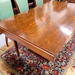 French Art Deco Figured Walnut dining table and six chairs. This stylish table also comes with a glass top and can be used with or without it. The chairs are very comfortable and the table can also fit another two chairs at either end making it a 6-8 seater. The table is in good original detailed condition with character marks to the top of table as shown in the pictures. This table and six chairs have been sourced locally.