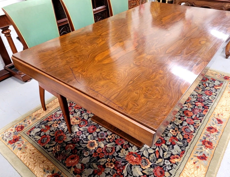 French Art Deco Figured Walnut dining table and six chairs. This stylish table also comes with a glass top and can be used with or without it. The chairs are very comfortable and the table can also fit another two chairs at either end making it a 6-8 seater. The table is in good original detailed condition with character marks to the top of table as shown in the pictures. This table and six chairs have been sourced locally.