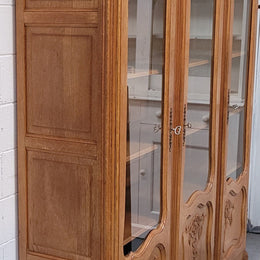 French Louis XV style light Oak three door bookcase with five fixed shelves. It has lovley glass doors and has been sourced from France. Is in good original detailed condition