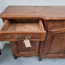 Parquetry top French oak Louis XV style sideboard with two draws and four cupboards. In good original detailed condition.