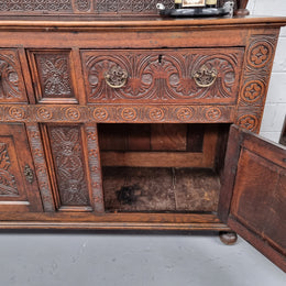 Impressively carved 18th Century English Oak kitchen dresser in 17th Century Jacobean style. It is in good original detailed condition and has been sourced from France.