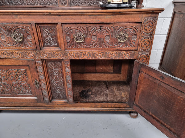 Impressively carved 18th Century English Oak kitchen dresser in 17th Century Jacobean style. It is in good original detailed condition and has been sourced from France.