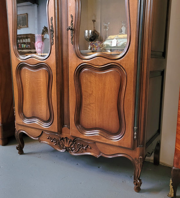 French Walnut Louis XV Style two half glass, door bookcase with three adjustable shelves. Sourced from France and in good original detailed condition.