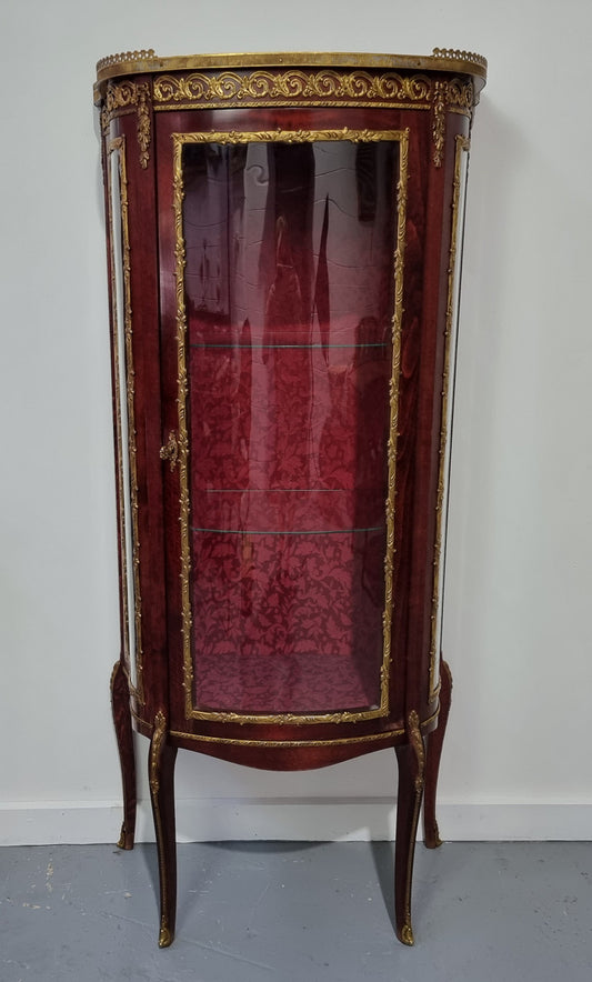 Louis XV style Walnut vitrine display cabinet with attractive ormolu mounts. Beautiful Maroon floral fabric backing with two glass shelves and cabriole legs with decorative ormolu mounts. In good original detailed condition.