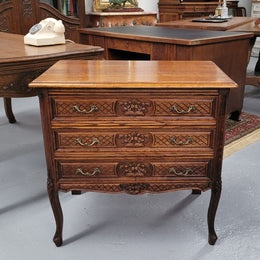 Rustic Louis XV style Oak petite three drawer chest featuring attractive carvings. It has been sourced locally and it is in good original detailed condition.