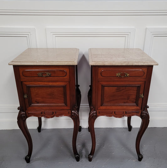 Pair of French Antiloopque Louis XV style Walnut and marble top bedsides. They have lovely carvings along with a drawer and cupboard space. They are in good original detailed condition and have been sourced from France