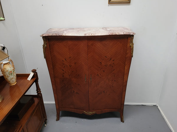 French Louis 15th style Kingwood marquetry inlaid two door cupboard with a beautiful marble top. It has three adjustable shelves and decorative ormolu trim. It has been sourced from France and is in good original detailed condition.