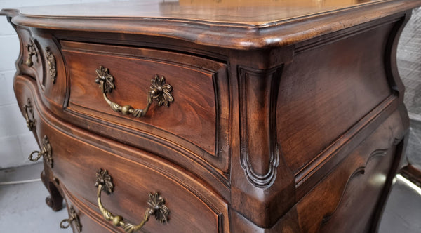 Impressive French Louis XV style Cherrywood four drawer commode, with a wooden top, two large drawers and two smaller drawers. Features attractive handles and a carved skirt and feet. In good original detailed condition.