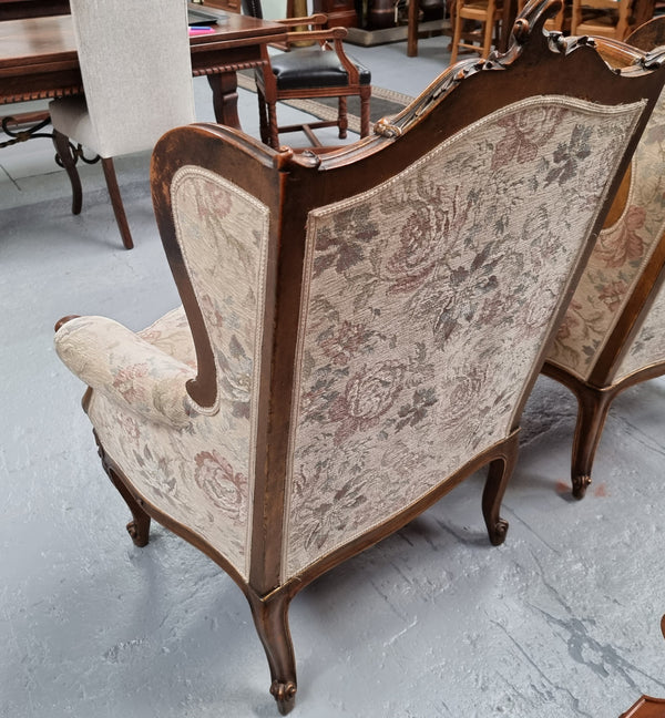 Lovely French pair of gilt and floral upholstered Bergere chairs with beautiful decorative carving in good original detailed condition.