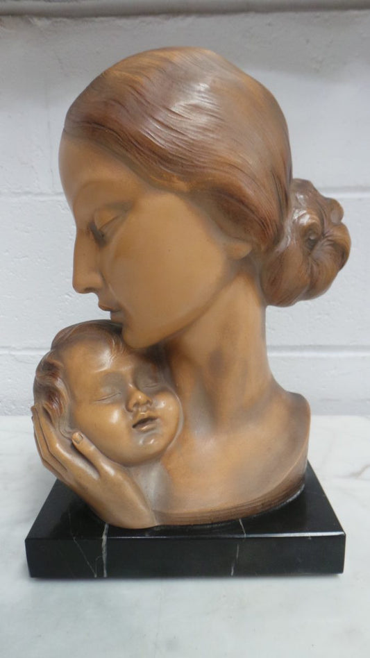 A beautiful Art Deco signed Terracotta mother and child bust statue, on a lovely black marble base in very good condition. Signed and made in Belgium.