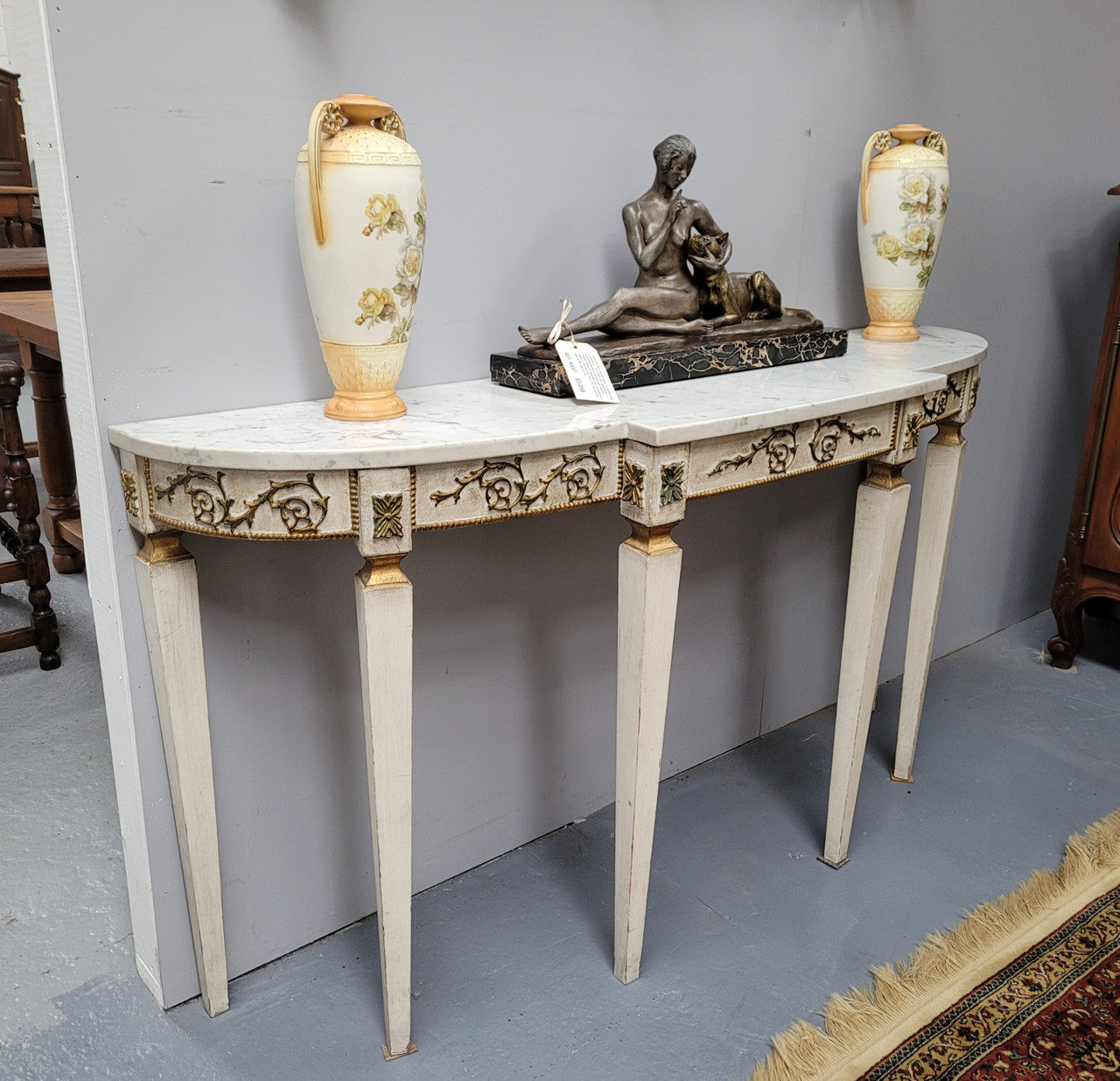 French Louis XVI style painted marble top console table. It is of pleasing narrow proportions and has been sourced from France. It is in good original detailed condition.
