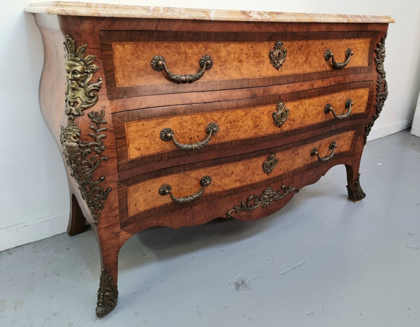 A beautiful French Louis XIV th style walnut and burr walnut commode of grand proportions . It has three large drawers and elaborate bronze mounts with a fabulous marble top . In very good original detailed condition.