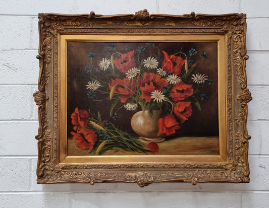 Lovely French signed floral oil on canvas of beautiful Poppies and Daisies in a ornate decorative frame. In good original condition.