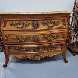 Impressive Louis XV style three drawer walnut commode. Ormolu handles and bevelled marble top complimenting detailed carving. In very good original detailed condition.
