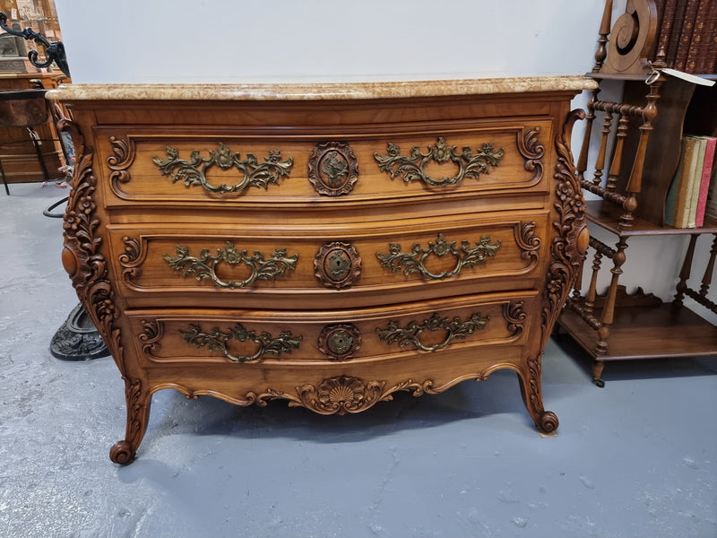 Impressive Louis XV style three drawer walnut commode. Ormolu handles and bevelled marble top complimenting detailed carving. In very good original detailed condition.