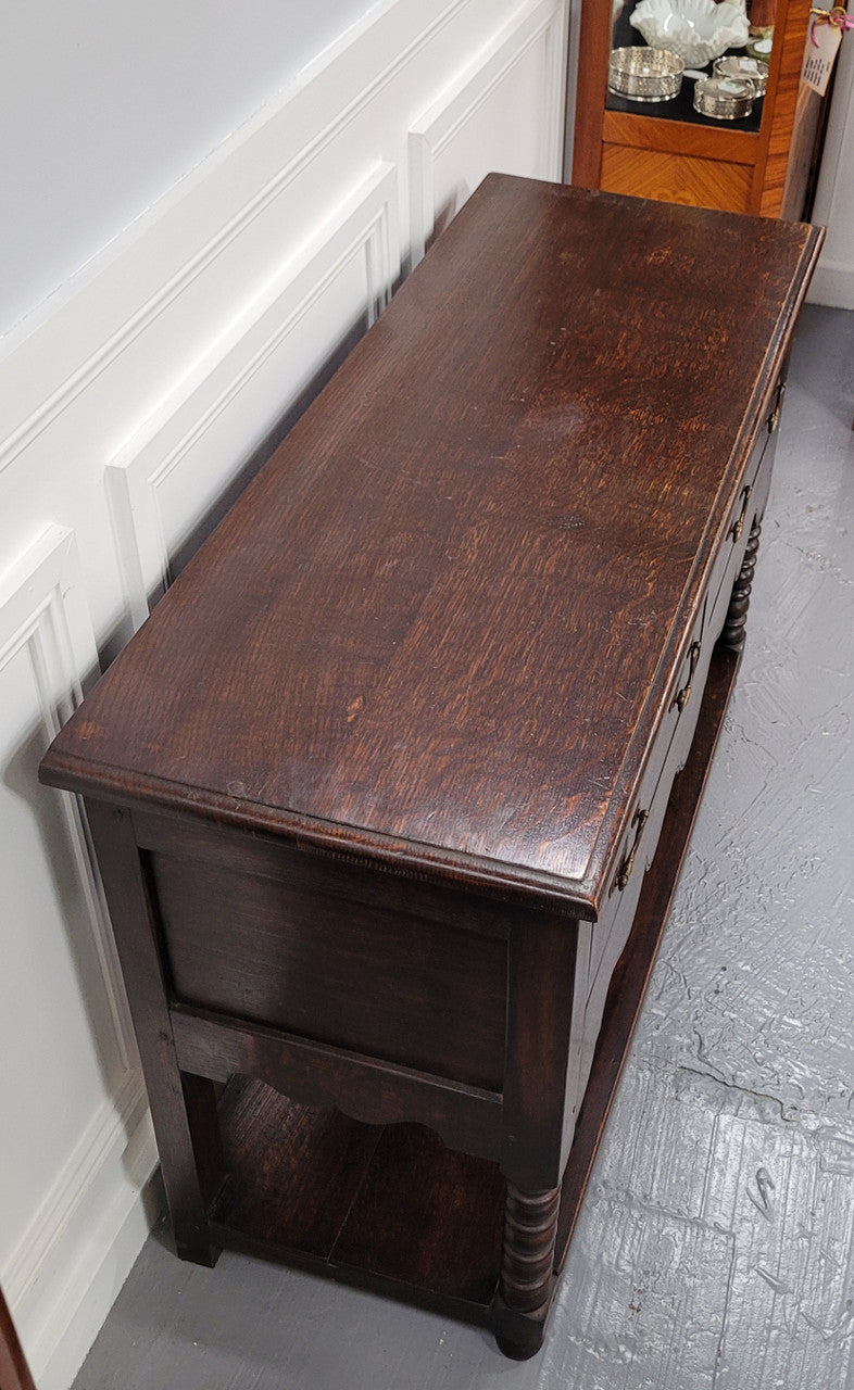 Rare size 19th Century English oak dresser base. It has two good size drawers and amazing patina. It has been sourced from France and in good original detailed condition.