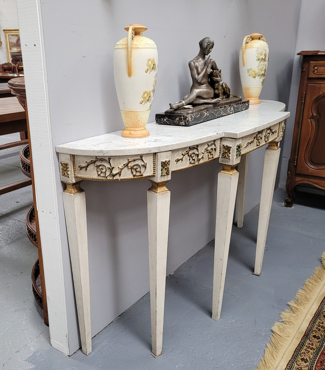 French Louis XVI style painted marble top console table. It is of pleasing narrow proportions and has been sourced from France. It is in good original detailed condition.