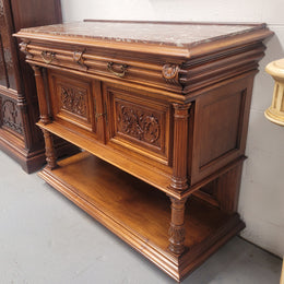 Stunning Henry II style French Walnut marble top buffet. It has a beautiful marble top and plenty of storage with two drawers, two doors with beautiful decorative carvings and an open shelf. It has been sourced from France and is in good original condition and has been detailed to a high standard.
