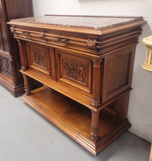 Stunning Henry II style French Walnut marble top buffet. It has a beautiful marble top and plenty of storage with two drawers, two doors with beautiful decorative carvings and an open shelf. It has been sourced from France and is in good original condition and has been detailed to a high standard.
