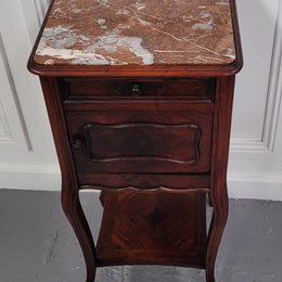 French Rosewood inset marble top single bedside cabinet with one drawer and one cupboard on elegant legs. Would also make a practical and stunning table lamp. It is in good original detailed condition.