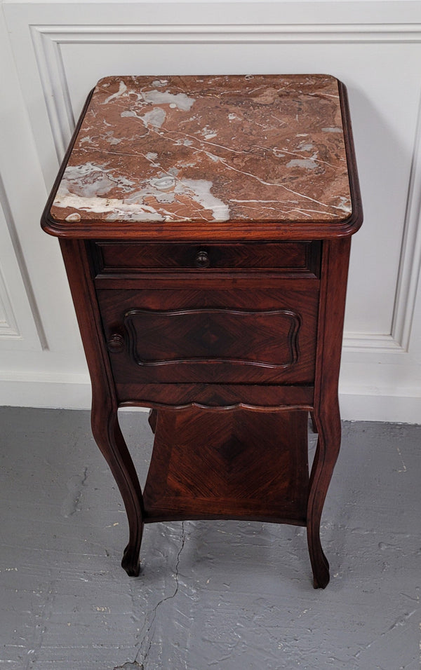French Rosewood inset marble top single bedside cabinet with one drawer and one cupboard on elegant legs. Would also make a practical and stunning table lamp. It is in good original detailed condition.