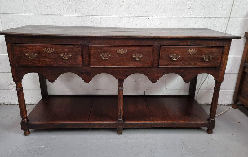 Antique 19th Century English dark Oak three drawer Dresser with brass handles and in good original condition.