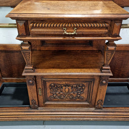 Grand Henry 2nd Style French Oak hall stand with 12 hanging hooks. Also has one cupboard and drawer for storage along with a mirror and two areas either side for umbrellas and walking sticks. In good original detailed condition.