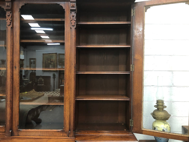 Amazing six-door Oak English bookcase sourced from France. The top section has adjustable shelves and plenty of storage space below which has fixed shelves. Keys and locks in working condition. In good original detailed condition. Circa 1880.