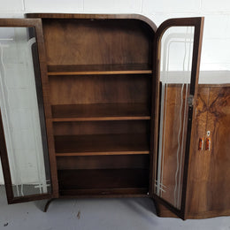 Art Deco Walnut display / drinks cabinet consisting of two glass door display and two door cupboard. Top section also lifts up and turns into a drinks area. All with original handles and in good original detailed condition.