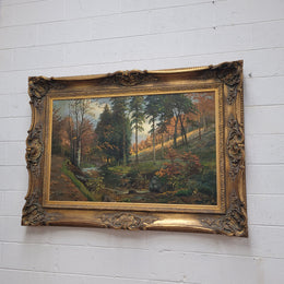 Large signed oil on canvas depicting a river stream in autumn framed in a stunning gilt frame. Sourced from France and is in good original detailed condition.