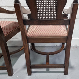 Pair oak Jacobean Revival carver chairs with cane back. In good restored condition with clean upholstery.